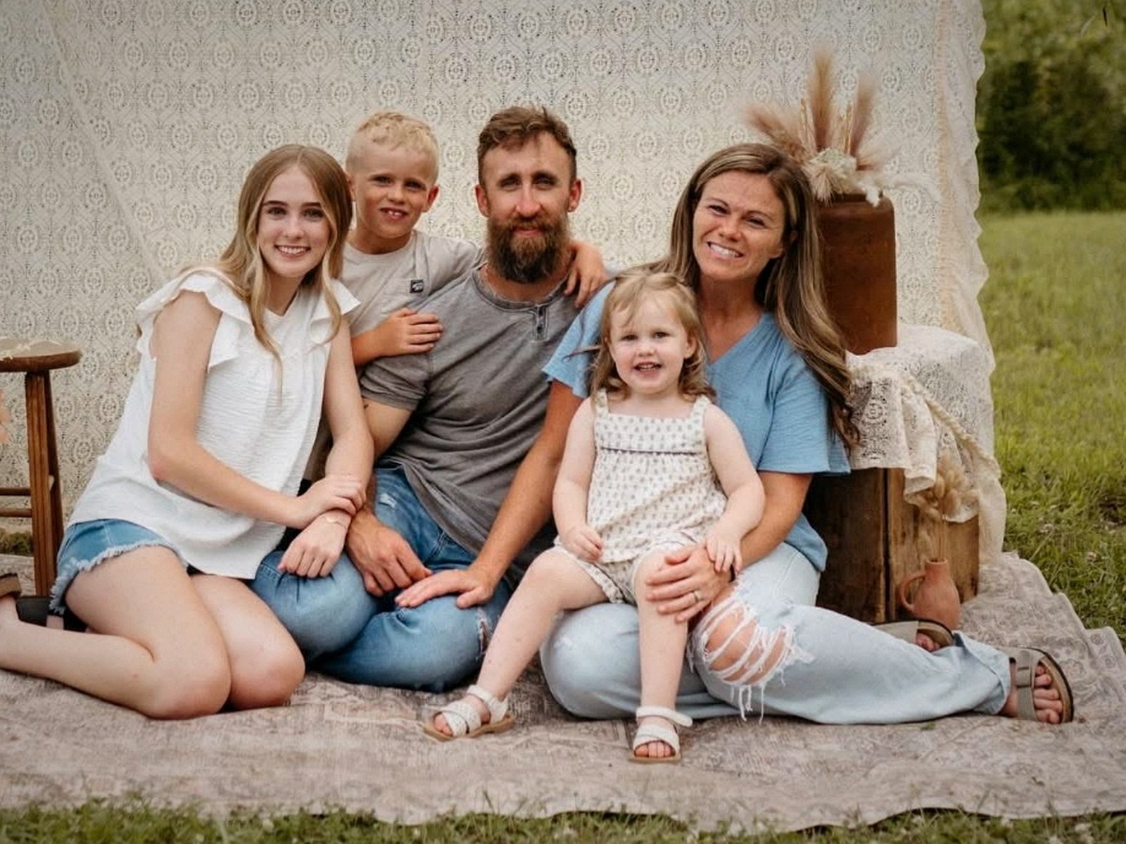 Brandon and Samantha with their three children, outdoors in Indiana