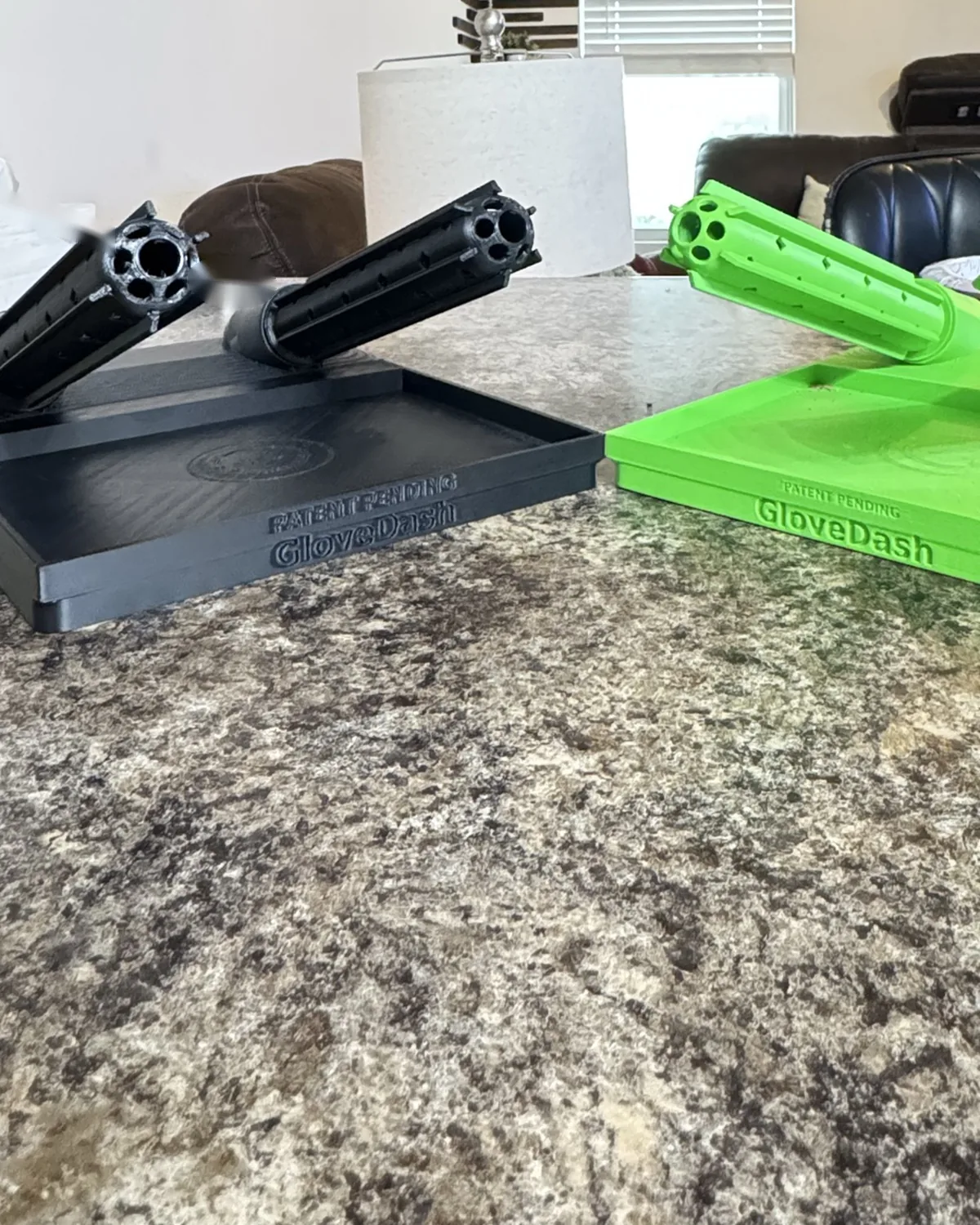 Two finished GloveDash units side by side on a counter, one all black and one safety green