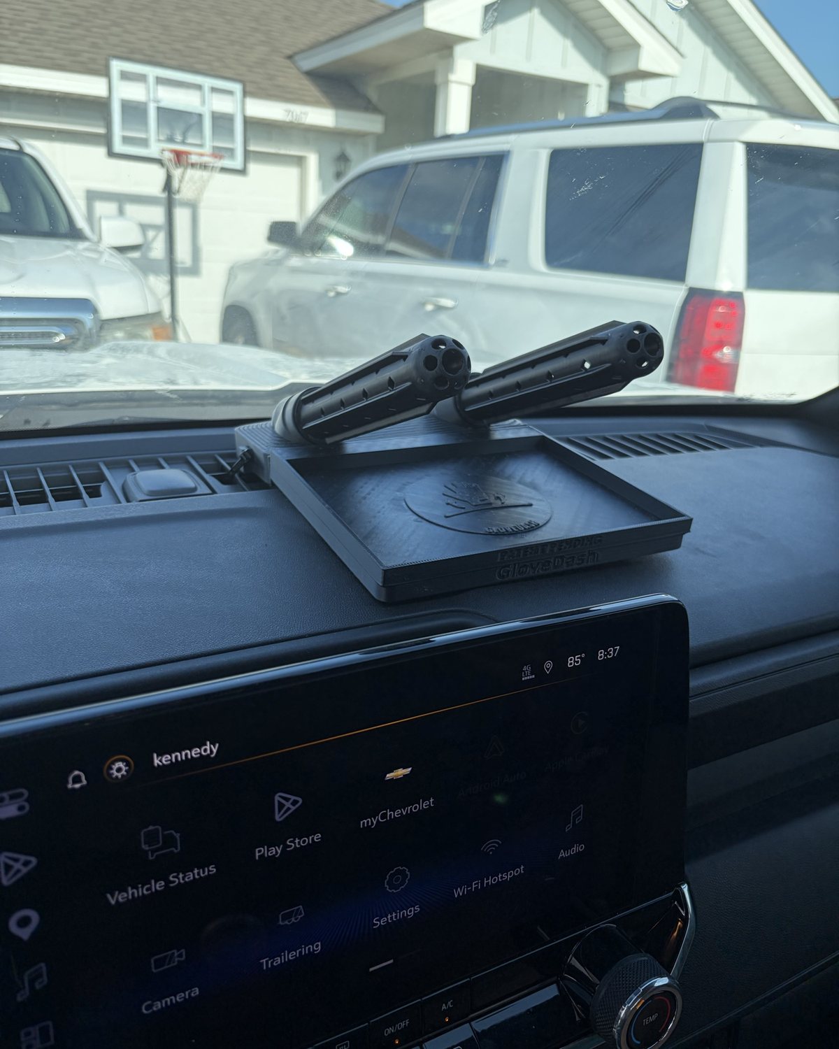 Black GloveDash mounted on a Chevy dashboard with Kennedy's name on the truck screen